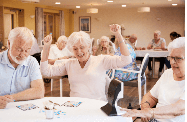 Senior woman enjoying Bingo in assisted living dining room in Rockford, IL